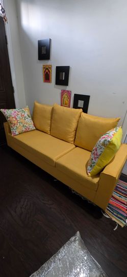 Yellow Fabric Sofa with Floral Pillows
