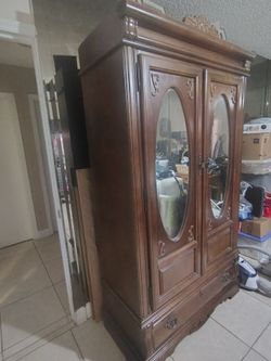 Beautiful wood armoire , glass at front.