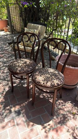 Set of two cane wood chairs leopard print fabric. wood is an excellent condition.