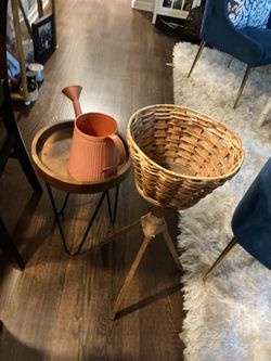A plant’s basket with legs, a plant table and water spray item (all for $15