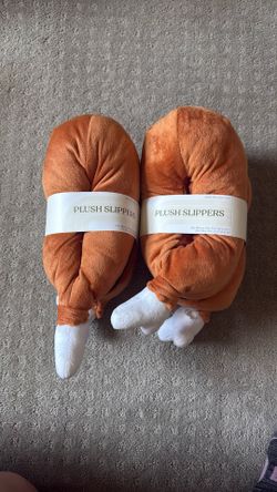 Plush turkey slippers, one small medium, the other medium large