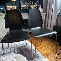 Two beautiful black wood chairs
