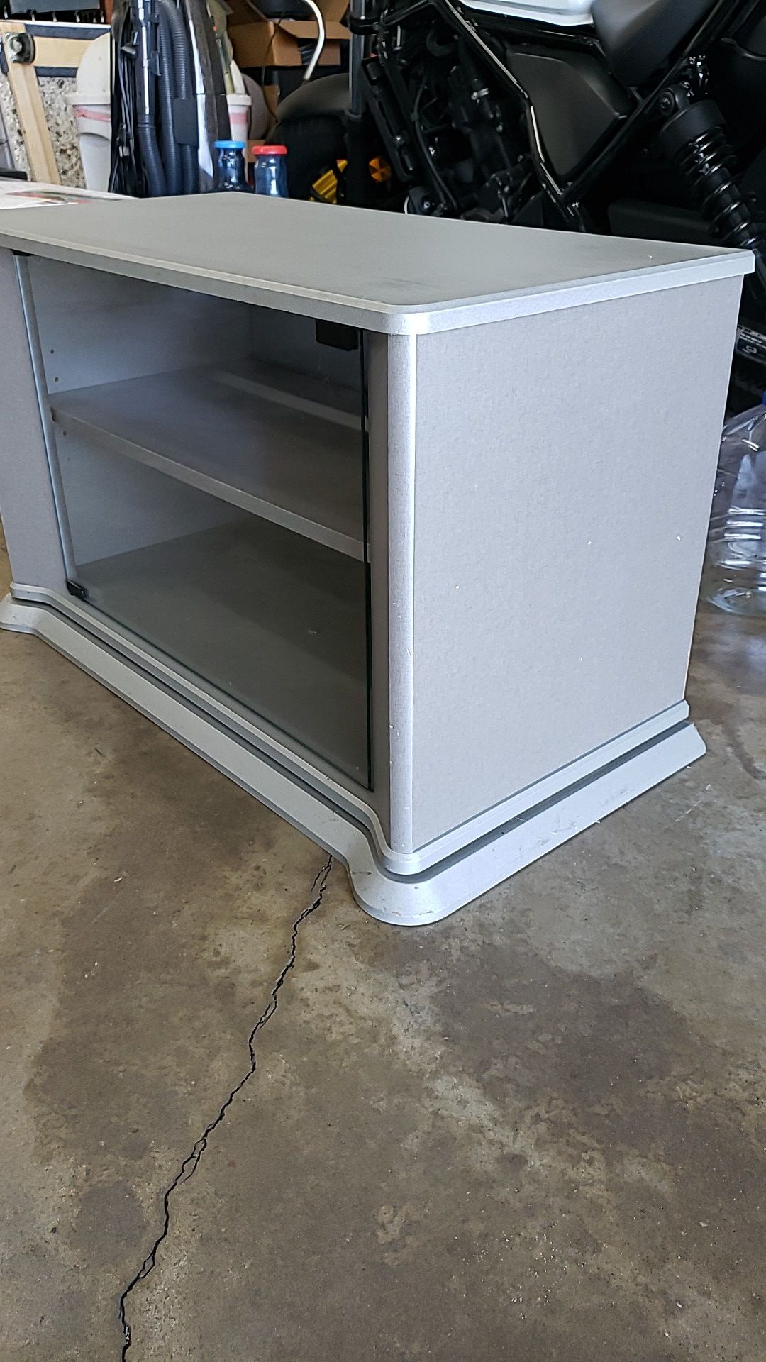 Swivel TV stand, grey, 2 shelves with glass door