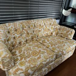 cute floral orange and yellow loveseat