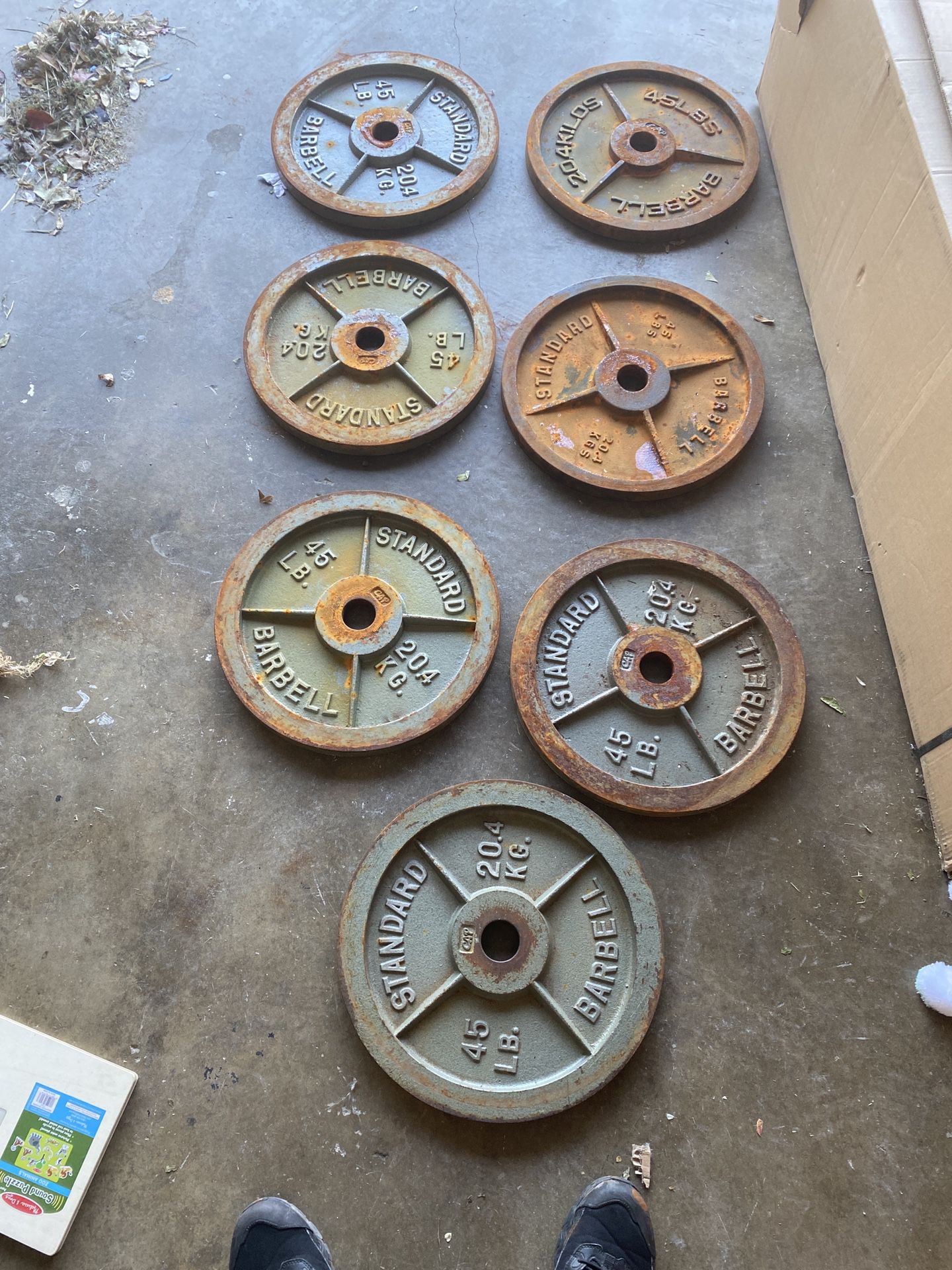 FIVE 45lb weights left . Rusted but easy to clean