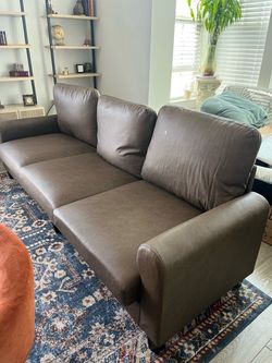 Brand new 100” faux leather sofa. Deep brown