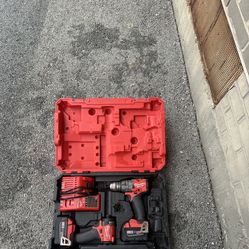 Milwaukee M18 Fuel Drill/Impact Driver Combo Kit with the charger, case, and batteries.