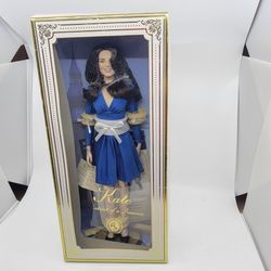 Franklin Mint 16-inch Portrait of a Princess vinyl doll Kate Middleton 
in her royal engagement outfit. New, in original box.
She has Brown Wavy Hair,