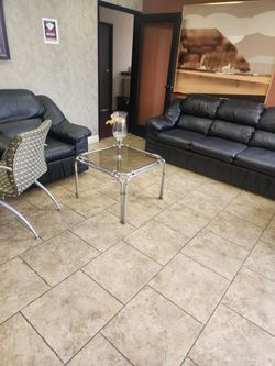 Two black leather couches