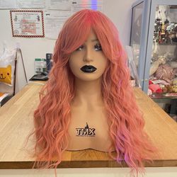 Human hair blend pastel peachy pink curly wavy wig.