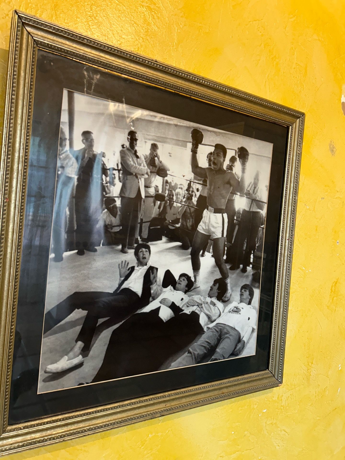 Muhammad Ali standing over the Beatles artwork Matt and frame 27“ x 25“Muhammad Ali standing over the Beatles artwork Matt and frame 27” x 25