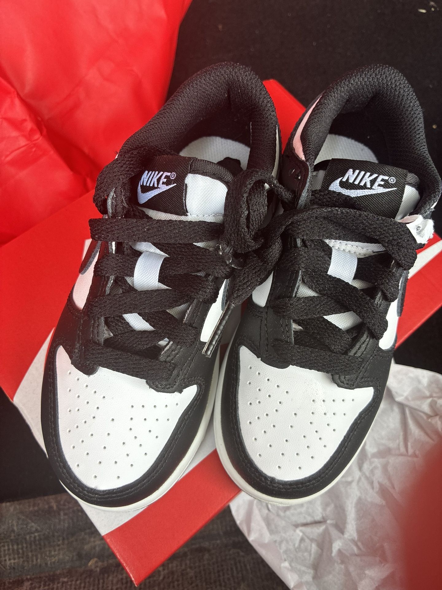 2 Pairs Of Nike Sneakers Brand New Size 1y And Size 11C $105.00 Black low top is 1Y And the Panda are size 11C $105.00 for both. And no negotiatio