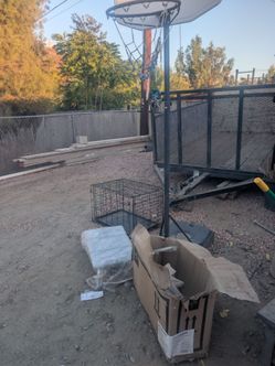 Dog cage , small basketball court and a bathtub transfer bench