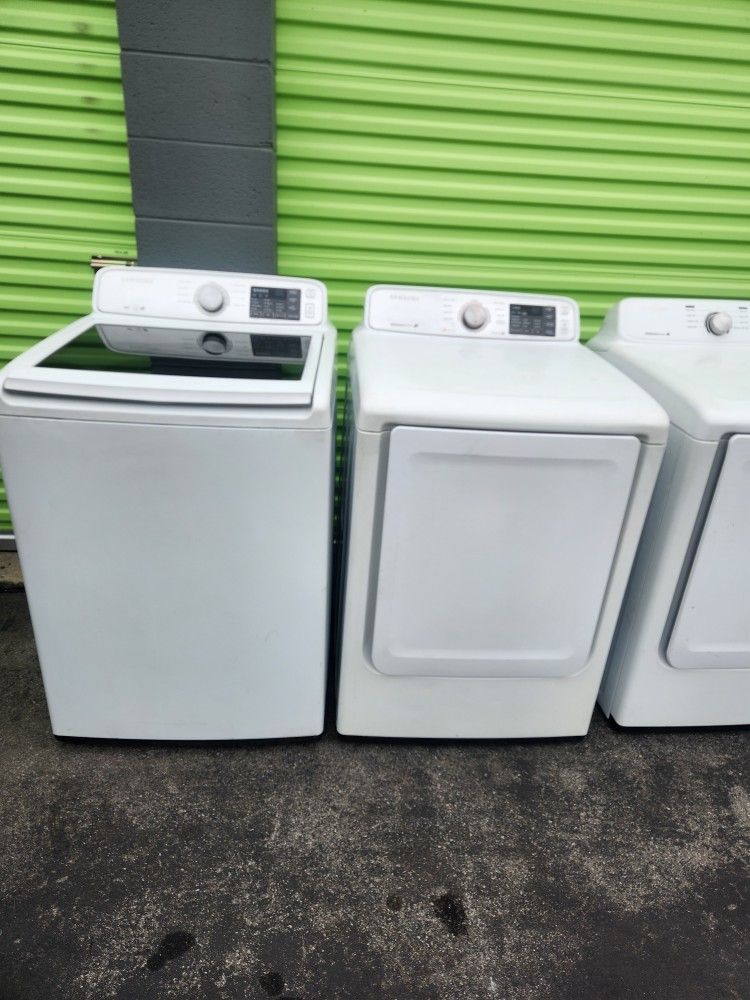 A pair of Samsung brand washing machines are gas and come with a 3-month warranty.