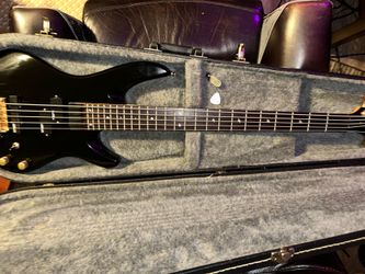 This is a vintage Samick Artist Series 5-string electric bass  part of the "Saturn" lineup