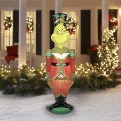 The DR SEUSS 6FT THE GRINCH NUTCRACKER LED BLOW MOLD LIGHTED YARD DECOR is a festive and whimsical addition to your Christmas décor.  