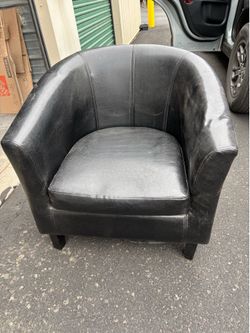 Smaller size black (faux?) leather club chair.