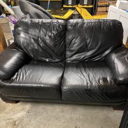 Black leather couch damages shown