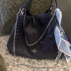 Coach Edie 31 midnight blue leather bag, with silver accents.