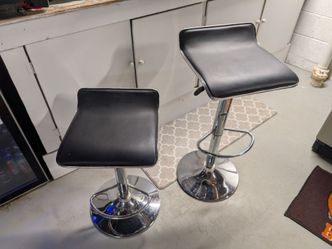 2 black and silver swivel bar stools with adjustable height