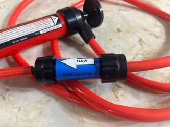 NWOT: Red & Black Pittsburgh Multi-Use Transfer Pump (or equivalent generic siphon pump) paired inline with a blue Sawyer Mini water filter.