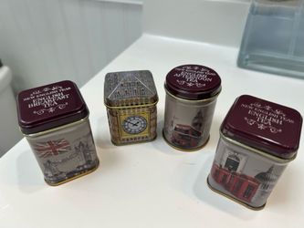 Four tins of the New English Teas "Traditions of London" or "Best of British" heritage gift packs.