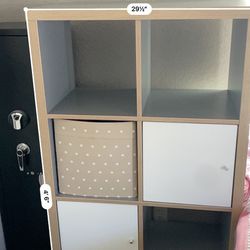 IKEA shelving unit with boxes and doors. 
