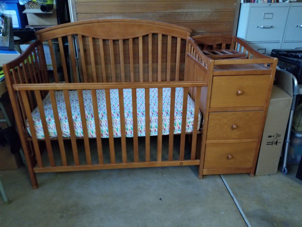 Baby crib with attached changing table.