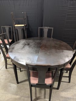 Dark Wood Oval Extendable Dining Table with Seven matching Chairs