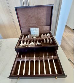 A 57 piece set of Adoration silverplate silverware by 1847 Rogers Bros of Waterbury, Connecticut in a beautiful box