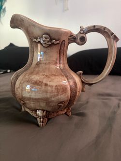 Antique Ceramic Pitcher with Ornate Relief Detail