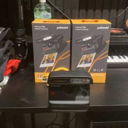 2 Polaroid  flip bundle with sixteen photos included and also includes carrying stamp