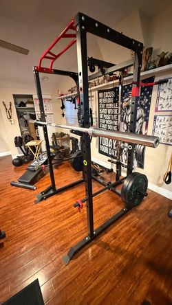 Squat rack with back n lower pulley system along with 140lbs of rubber weights