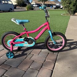 Schwinn kids bike with 14-inch wheels, training wheels, adjustable seat, front basket, and chain guard for safe, stylish riding.