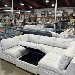 Light grey Thomasville sectional with storage ottoman