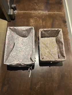 Two baskets covered with fabric for organizing items