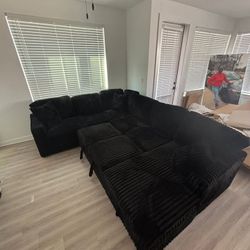BRAND NEW LARGE BLACK CORDUROY SECTIONAL WITH STORAGE AND PULL-OUT BED