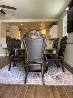 Elegant solid wood dining table with eight chairs