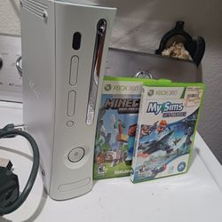 X BOX 360 system video game console. it works good , but doesn't come with controllers.  2 games included. 