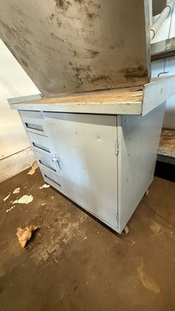Steel fabricated wheeled bench with cabinets. 29” tall, 3ft in length by 28” in width.