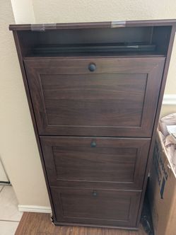 Dark brown wood-look finish shoe cabinet with three tilt-out compartments