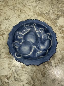 The image is a blue and white ceramic serving bowl with a ruffled edge and hand-painted fruit motifs, possibly from Thailand. 