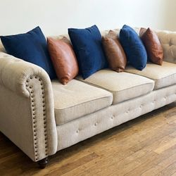 82" Tufted Beige Couch with Nailhead Trim (Includes 6 Pillows!)