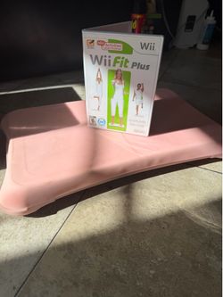 Nintendo Wii Fit Plus game with pink Wii Balance Board