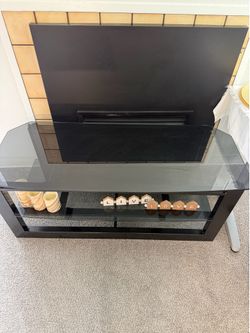 TV stand. Glass. Like new.