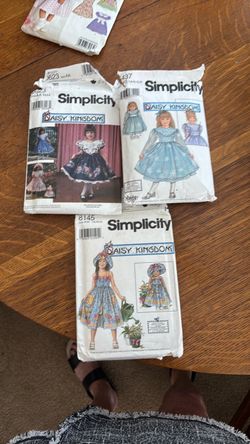 3 Daisy Kingdom dress patterns.  Each dress pattern comes with a doll dress pattern that will fit American girl doll.
