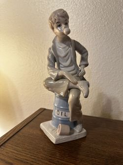Llardo Statue “Boy Blowing Bubble Gum Sitting On Oil Can”