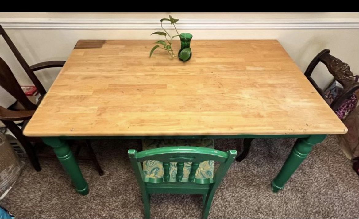 Dining table with three chairs and stain