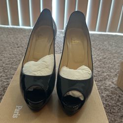Black patent Louboutin Peep toe pumps. Size 8