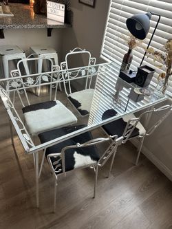 Table And Cow Hide Chairs 